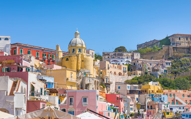 Vibrantly colorful housing of Marina Corricella in sunny summer weather at Procida island, Italy