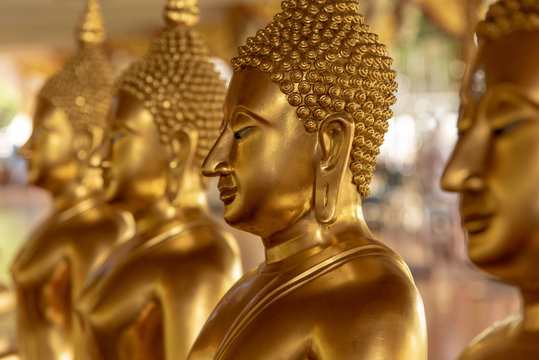 Closeup face of gold Buddha statue in thai temple