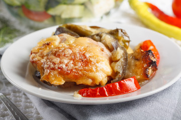 Traditional rustic stew of chicken and vegetables on plate with tomatoes, peppers