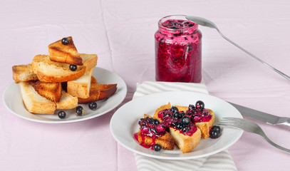 Delicious toasts bread with homemade currant jam with fork and knife