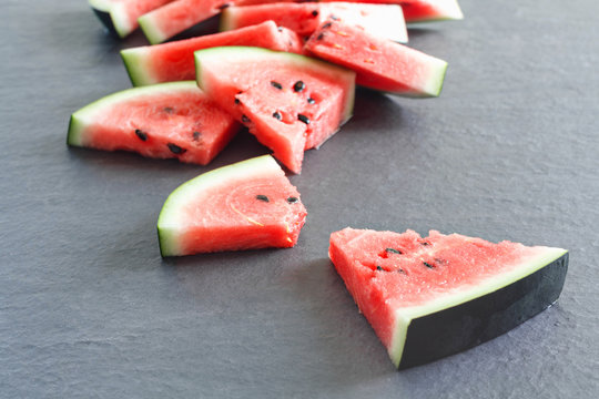 Pieces of juicy ripe watermelon slices on  stone countertop