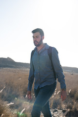 Fototapeta premium Man walking in the desert looking down
