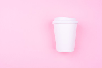 White Paper coffee cup on pink pastel colorful paper flat lay background. Takeaway drink container. Template of drink cup for your design for put text, image, and logo mockup