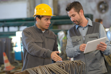 two workers working in a factory