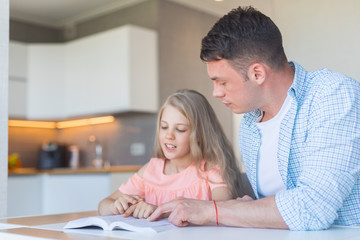 Family reading a book at home