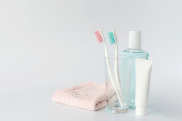 Toothbrushes, toothpaste, rinse and towel on white background. Dental and healthcare concept. Free...