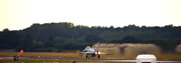 military fighter jet taking off from air base