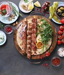 
    Kebab. Traditional middle eastern, arabic or mediterranean meat kebab with vegetables and herbs. Overhead view, copy space