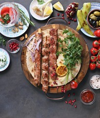 
    Kebab. Traditional middle eastern, arabic or mediterranean meat kebab with vegetables and herbs. Overhead view, copy space