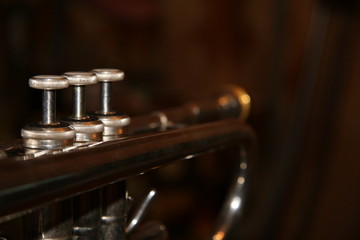Obraz na płótnie Canvas The trumpet valves on tha black background