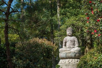 Japanese Buddha statue in a temple garden in Kyoto