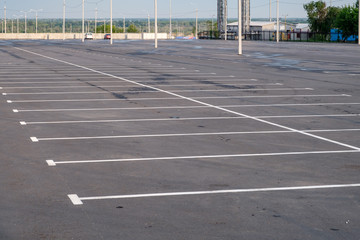 A deserted parking lot with crowds in the middle against the background of the blue cloudy sky.