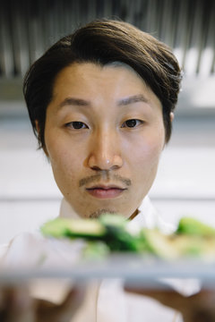 Japanese cook with food plate