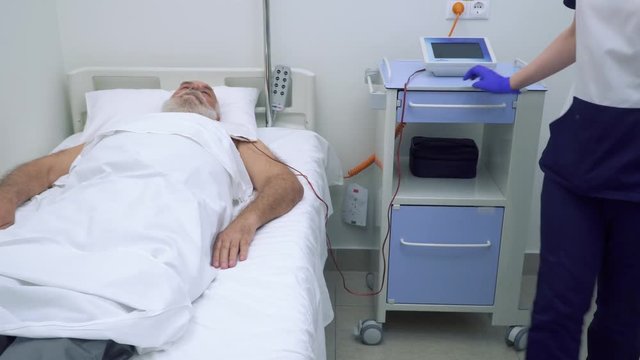 Doctor checking the patient during the procedure of electrophoresis