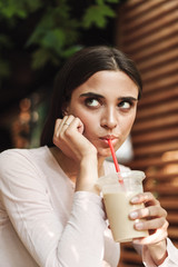 Close up of a young brunette girl leaning on her arm