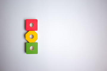 red yellow and green cubes in the form of a traffic light on a white background, copy space, learning the rules of the road