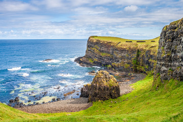 Landscape of cliffs at Dunluce Castle on Antrim coast, Northern Ireland