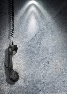Black old handset with a wire hang against concrete wall. 3d rendering