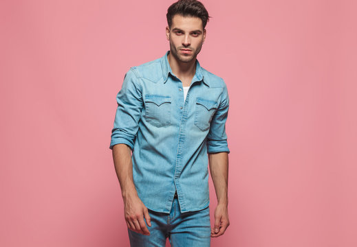 portrait of handsome man wearing denim shirt with rolled sleeves