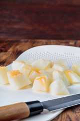 juicy appetizing melon on a cutting Board, cut into cubes for serving a cold dish