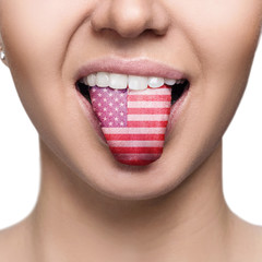 Young woman showing tongue with american flag.