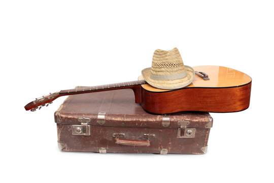 Old suitcase and guitar in country style on a white background