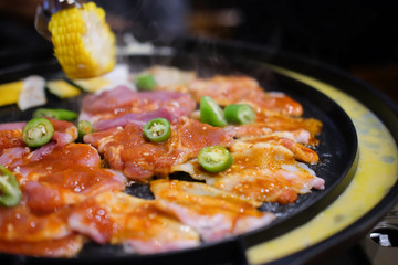 Meat are being cooked on korean stove