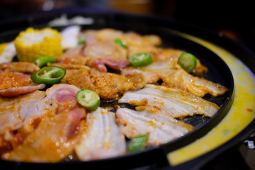 Meat are being cooked on korean stove