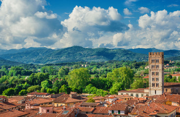 Panorama of the medieval center of Lucca with the romanesque Basilica of San Frediano (St Fridianus)  and the Apennines mountains in the background