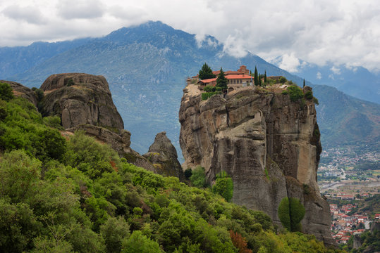 Magnificent autumn landscape. Monastery Holy Trinity, Meteora, Greece. UNESCO world heritage Site. Epic landscape with temple at the edge of cliff at dramatic sky background.