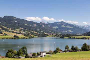 Fototapeta premium Gruyeres lake with the alps in the background in Canton Fribourg in Switzerland