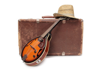 Old suitcase and mandolin in country style on a white background