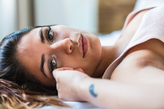 Alluring slim woman lying on bed