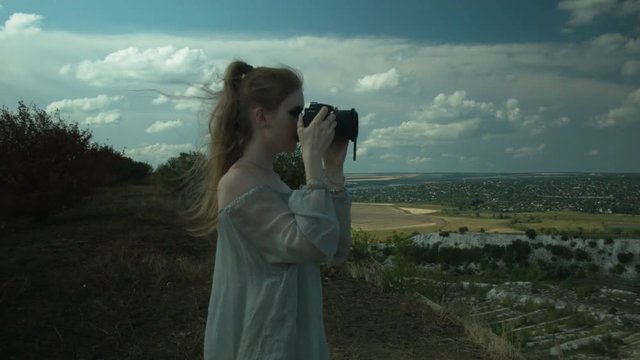 Beautiful young girl taking pictures of nature