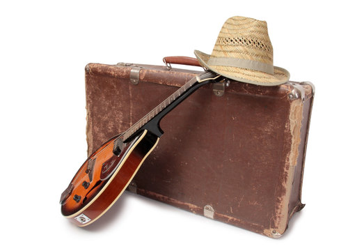 Old suitcase and mandolin in country style on a white background