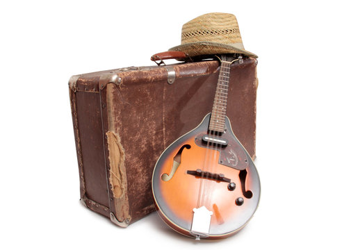 Old suitcase and mandolin in country style on a white background