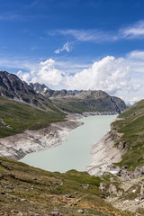 Obraz premium The Grande Dixence lake, formed by a dam, in the Swiss alps in Canton Valais on a sunny summer day