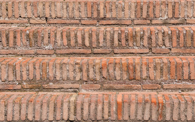 Old red brick steps with mortar as background