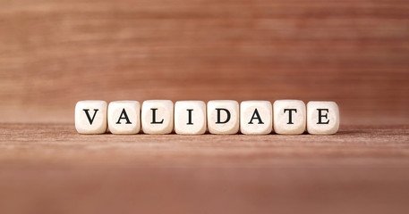 Word VALIDATE made with wood building blocks