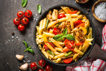 Pasta penne with chiken and vegetables. - obrazy, fototapety, plakaty