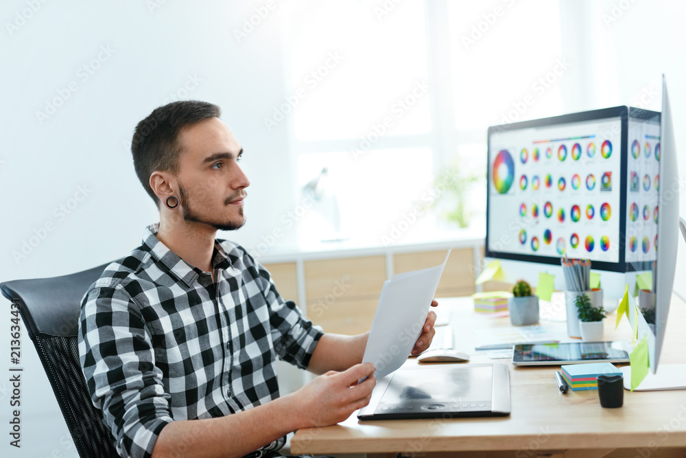Poster Web Designer Working On Design Project In Office.