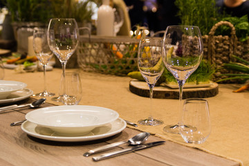 Empty wine glasses near the plates on the table