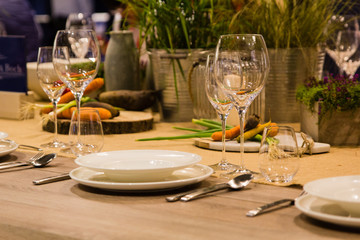 Empty wine glasses near the plates on the table