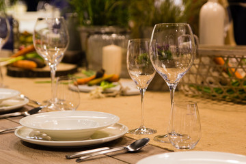 Empty wine glasses near the plates on the table