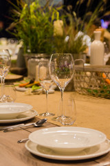 Empty wine glasses near the plates on the table