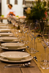 Empty wine glasses near the plates on the table