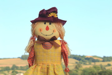 Cutestraw filled girl scarecrow on a farmland in East Devon