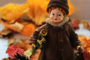 Fototapeta premium Girl with Christmas gifts makes a transition from autumn to winter concept