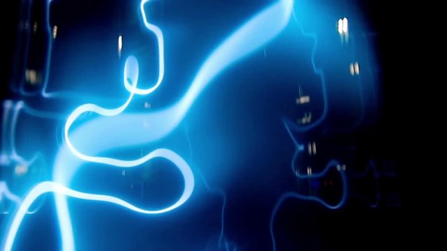Plasma tunnel with blue and light blue flashes. Big electric shocks in an path. Blue lightning storm on a black background, electricity and power out of control. Energy, science and magic showed