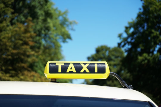 german taxi sign on car roof